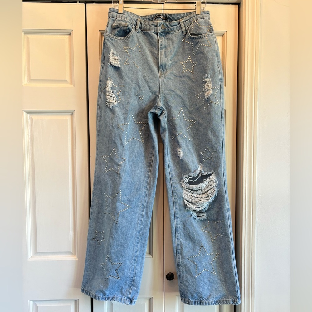 Boohoo, distressed light blue jeans with studded stars on the front, 10